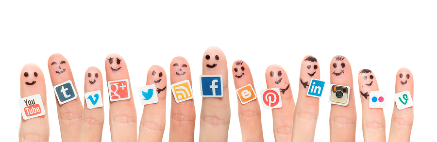 Finger With Popular Social Media Logo Printed On Paper.